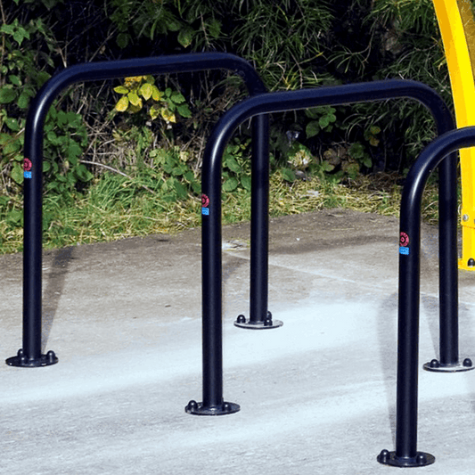 This Sheffield Cycle Stand is made from mild galvanised steel, with a black coated finish. Available in both concrete in and bolt down fixtures, this cycle stand can be used in many different applications. These include transport hubs, public parks, workplaces and schools.

Its innovative tubular design allows bikes to be secured by the frame, wheels and forks. The 48mm diameter tube size allows for most bike locks to be fitted with ease.